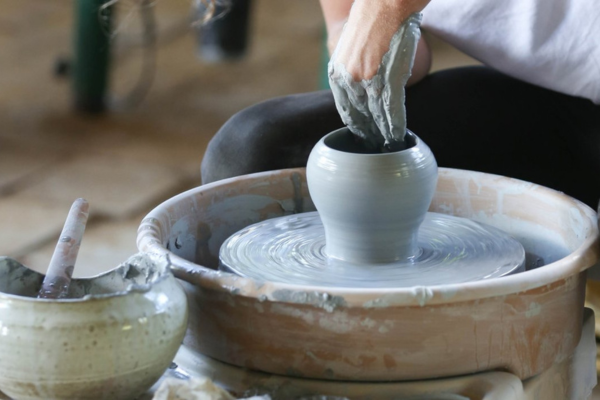 Potter using a wheel to create a vase
